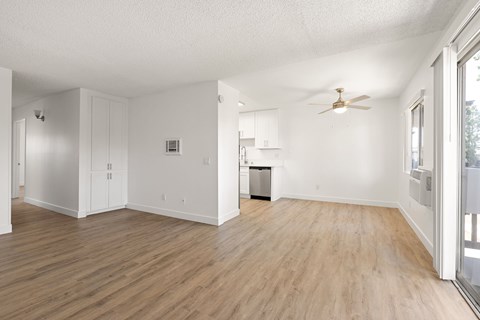A room with wooden floors and white walls.