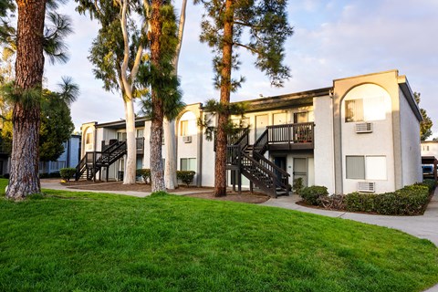 A building with a white facade and a black staircase.