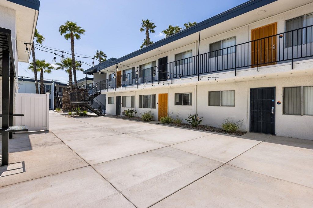 A sunny day at a modern apartment complex with a courtyard.