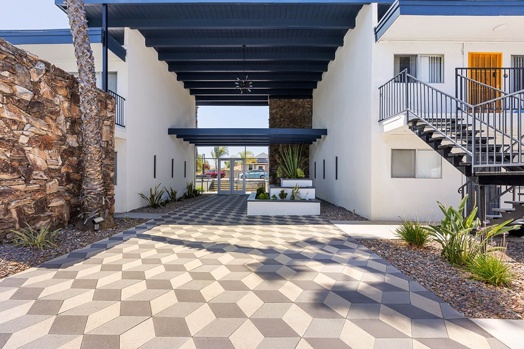 A modern house with a checkered floor leading to a balcony.