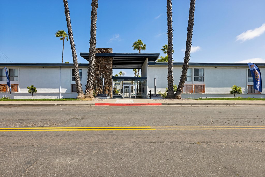 A building with a palm tree in front of it.