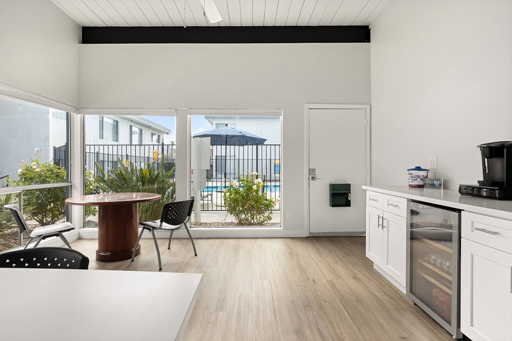 A kitchen with a table and chairs is shown.