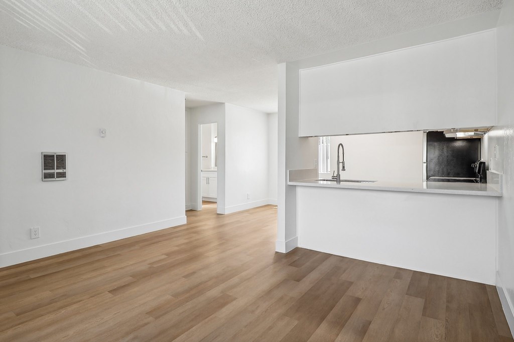 A kitchen area with a counter and a sink.