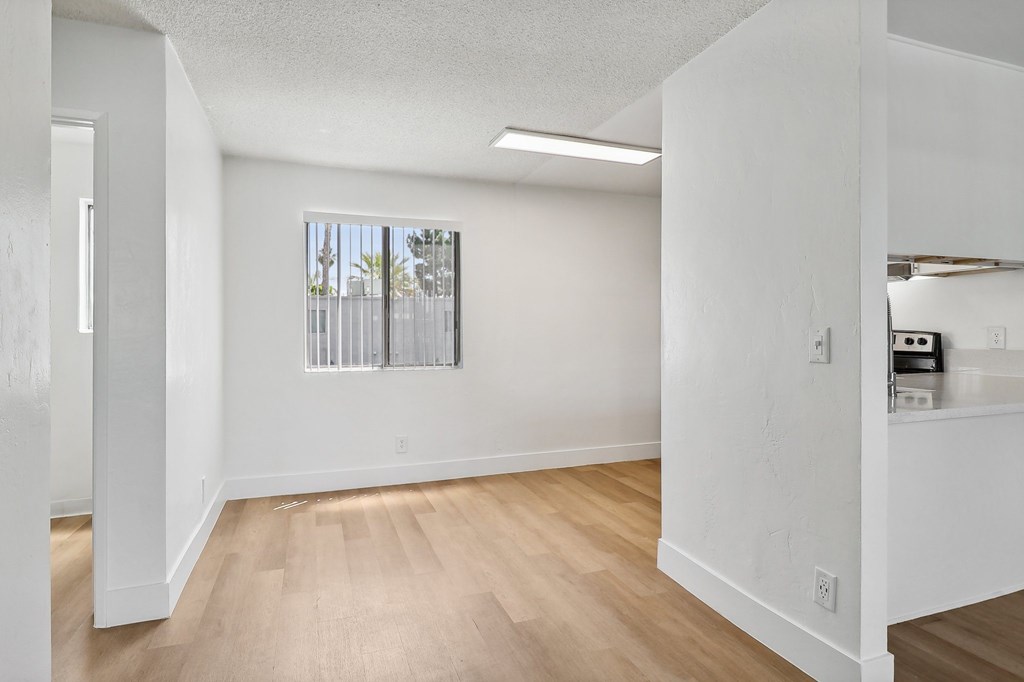 A room with white walls and wooden flooring.