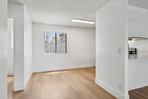 A room with white walls and wooden flooring.