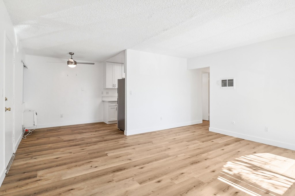 A room with wooden floors and white walls.