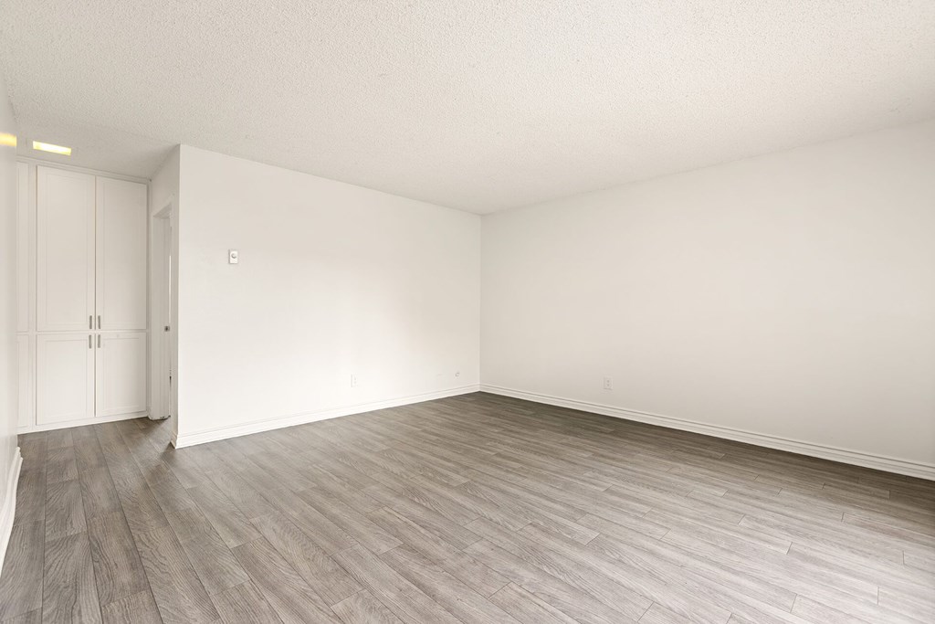 A room with a wooden floor and white walls.