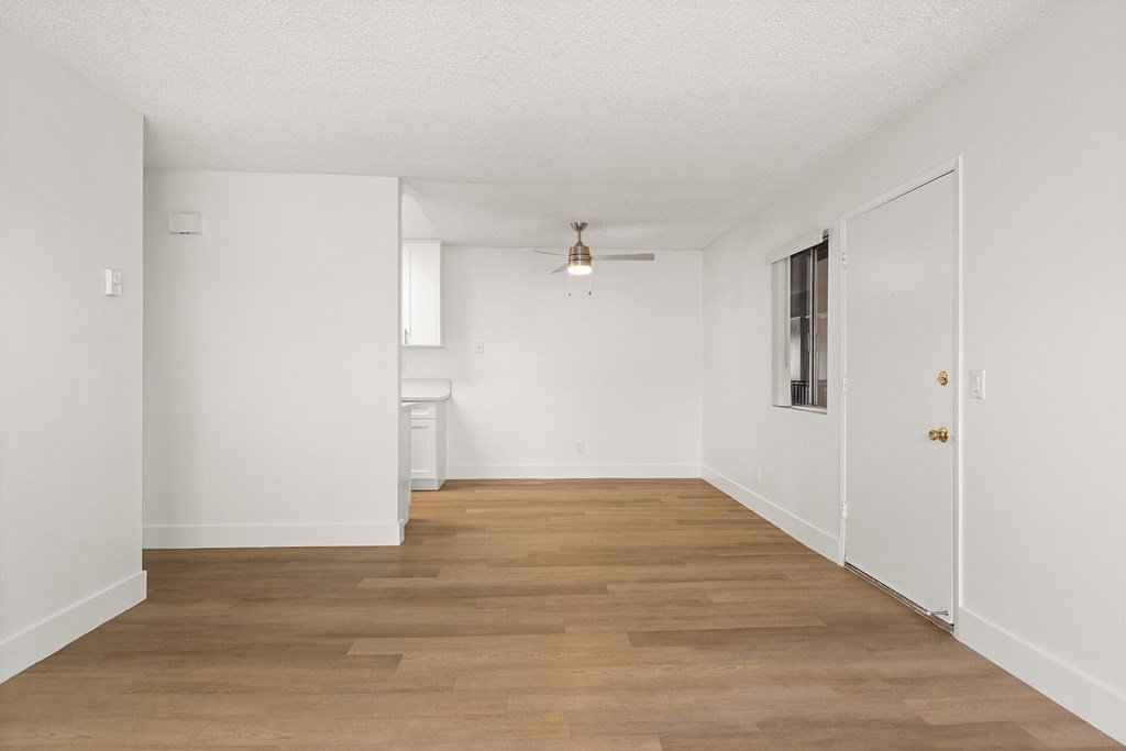 A room with wooden floors and white walls.