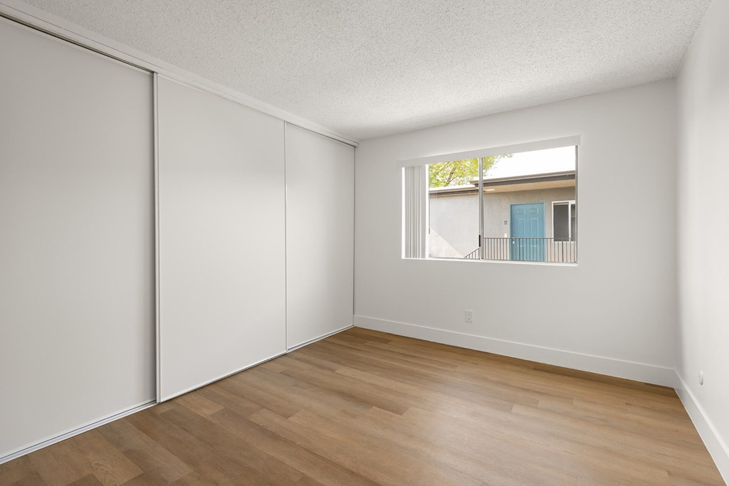 A room with a sliding door and a window.