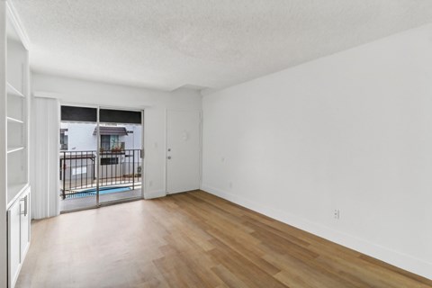 A room with wooden floors and white walls.