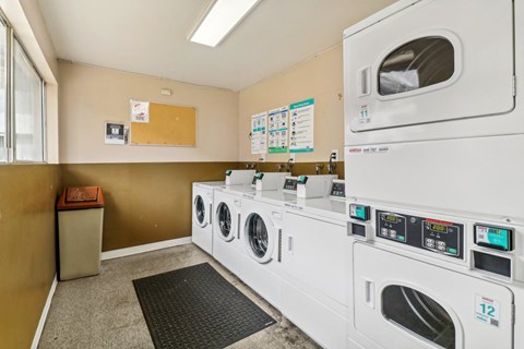 A row of washing machines in a laundromat.