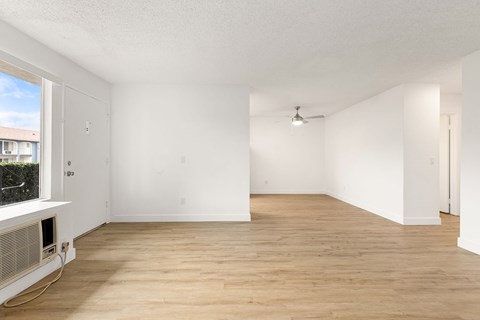 Empty room with wooden floor and white walls.
