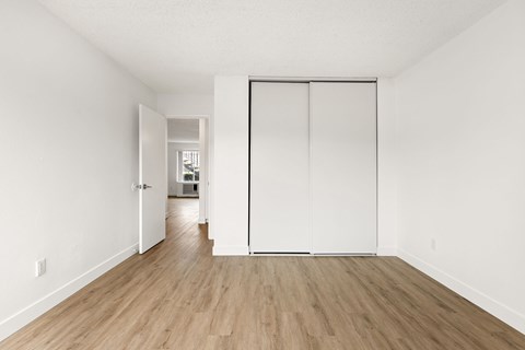 A room with a white wall and a white door.