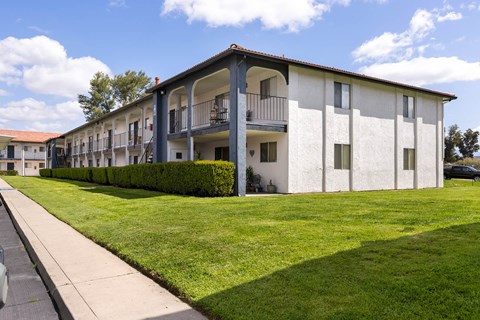 A white building with a balcony on the second floor.
