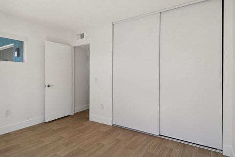 A room with a white door and a white wall.