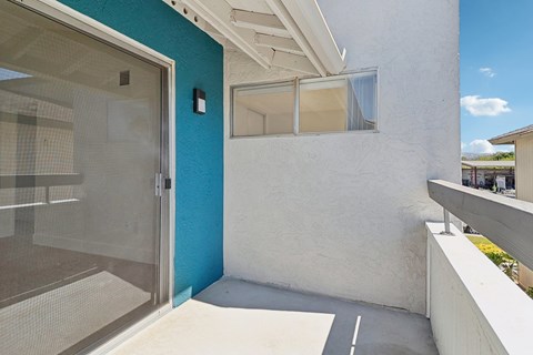 A modern house with a blue wall and a glass door.