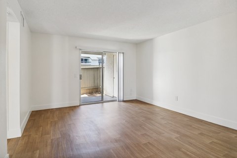 A room with wooden floors and white walls.