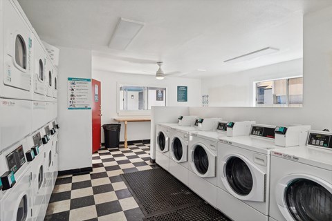 A row of washing machines in a laundromat.