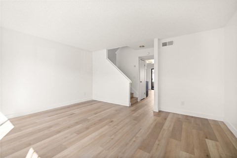 A room with wooden floors and white walls.