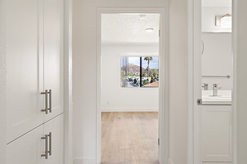 A bathroom with a white sink and cabinet.