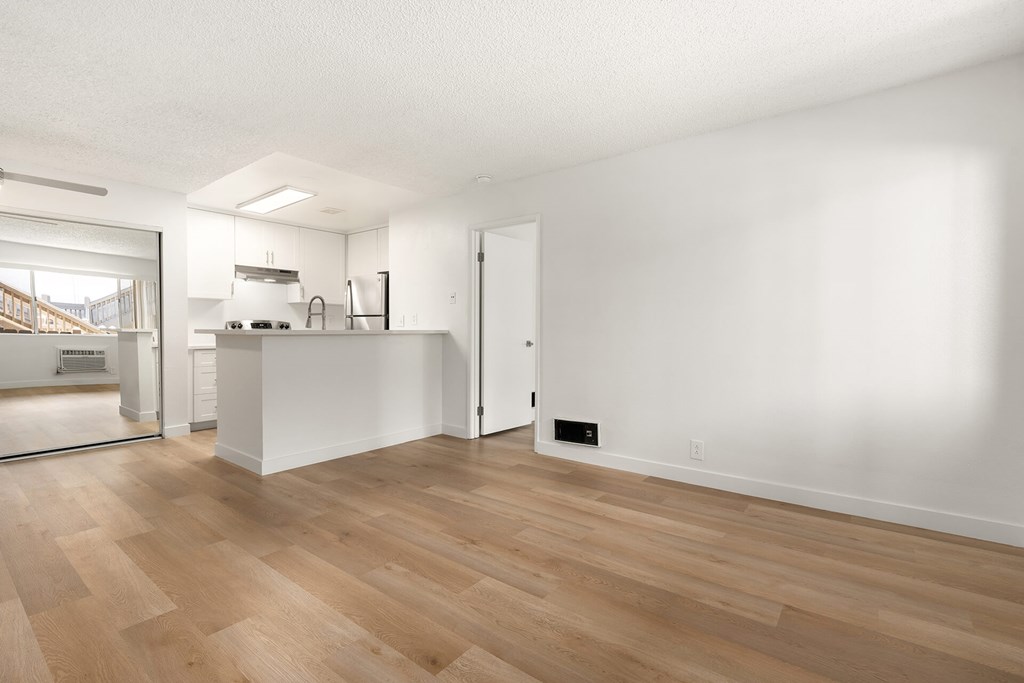 A room with wooden floors and white walls.