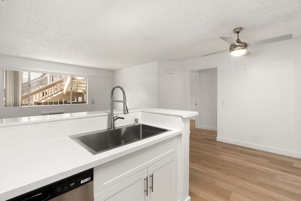 A kitchen with a sink and a window.