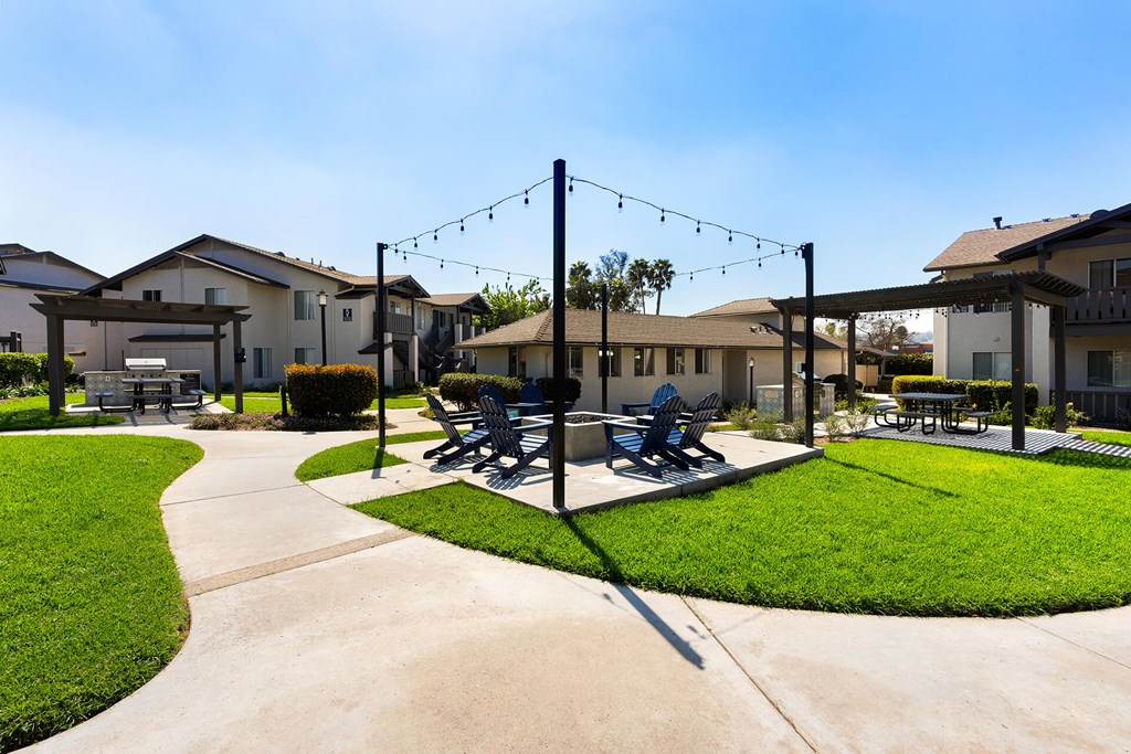 A park with a bench and a swing set.