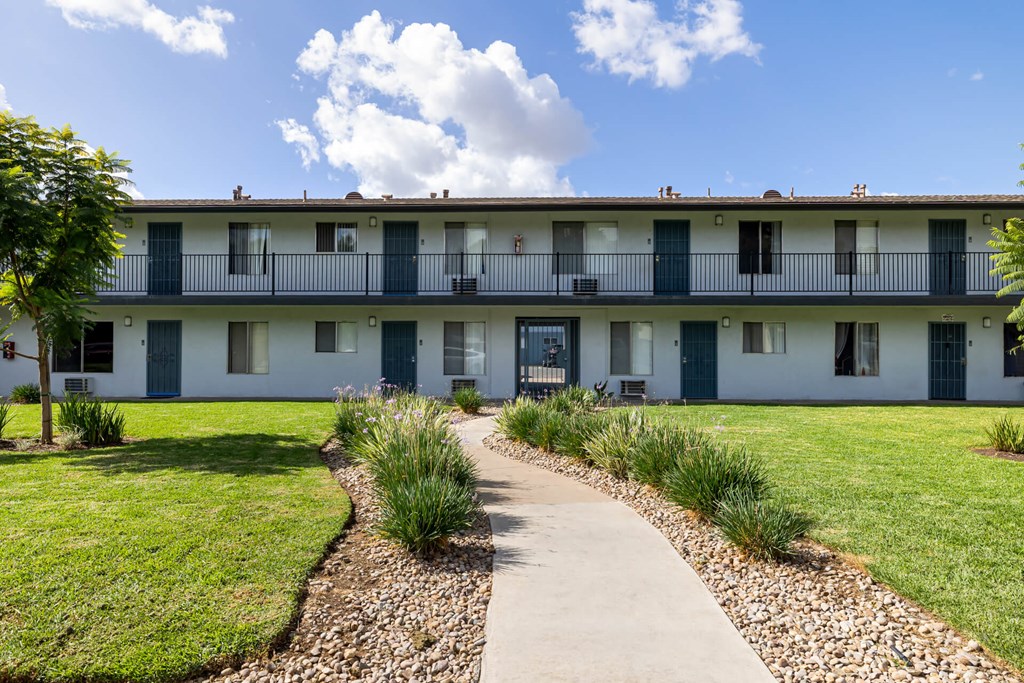 A building with white walls and blue doors.