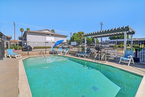 A swimming pool with a blue tarp covering the top.