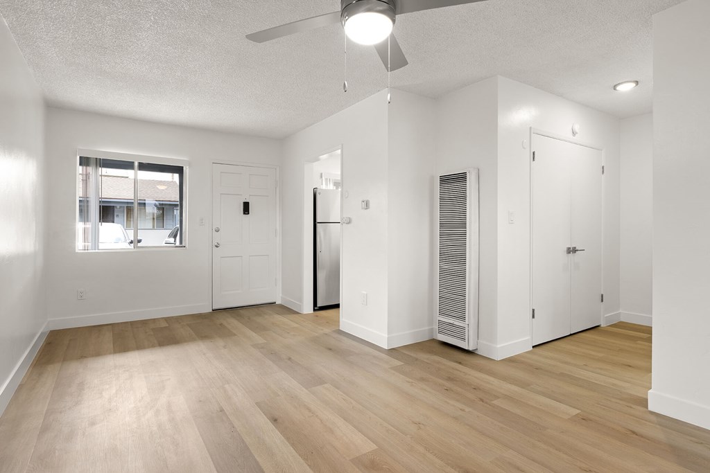 A room with a ceiling fan and a window.