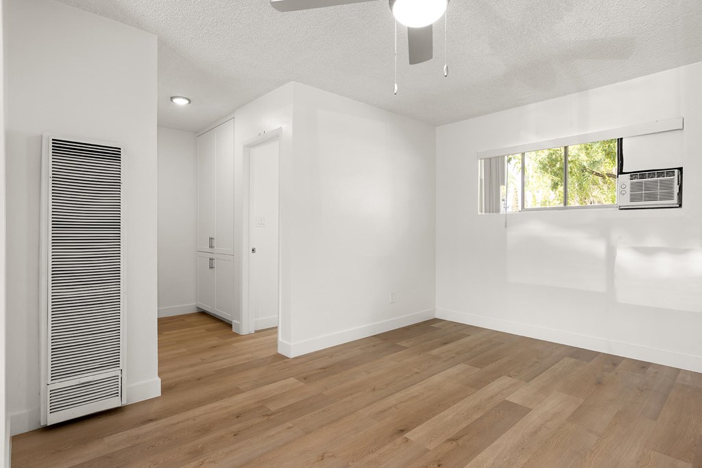 A room with wooden floors and white walls.