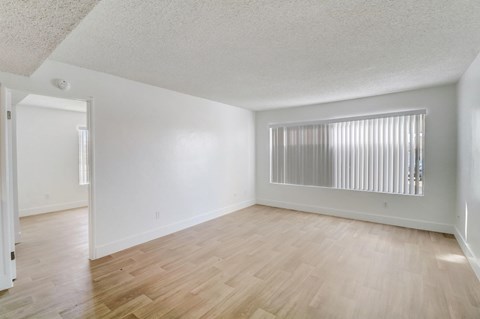 A room with wooden floors and white walls.