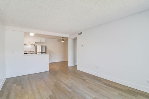 A kitchen area with a stainless steel refrigerator and stove top oven.