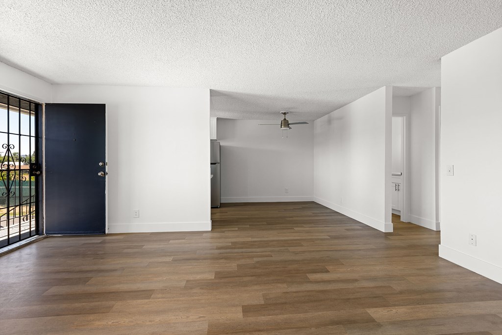 A room with a dark blue door and wooden flooring.