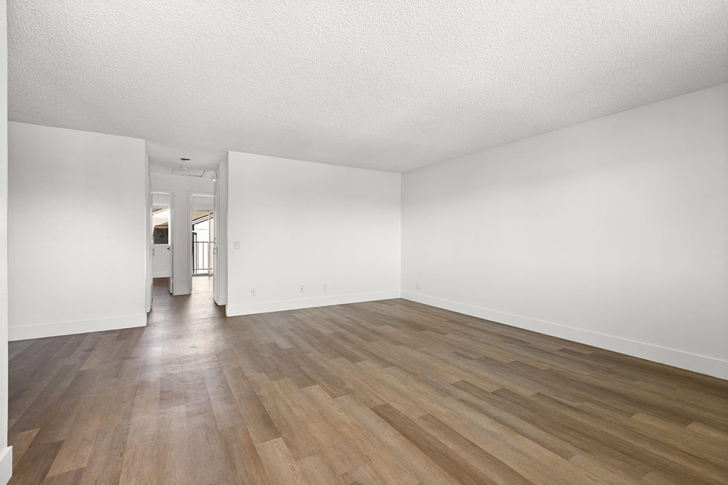 A room with wooden floors and white walls.