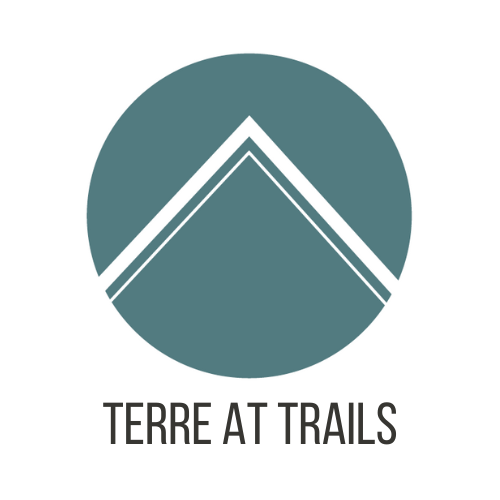 A logo with the text "TERRE AT TRAILS" below it.