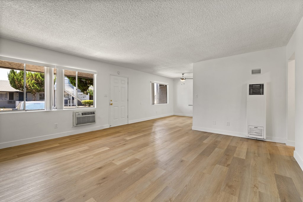 A room with wooden floors and white walls.