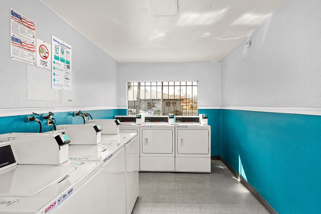 A clean, well-organized laundry room with washers and dryers.