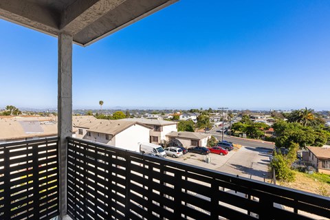 A view from a balcony overlooking a residential area.