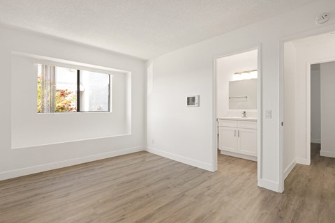 A room with a window and a door.