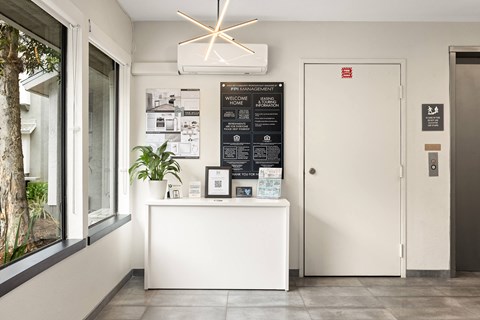 A white reception desk with a sign that says