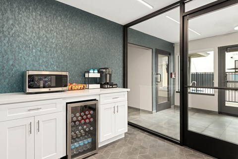 A kitchen with a refrigerator filled with bottles.