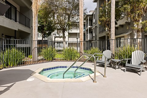 A small pool with a metal fence around it.