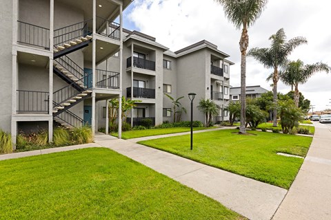 Apartment complex with a green lawn in front.