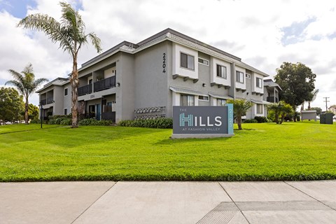 A building with a sign that says Hills in front of it.