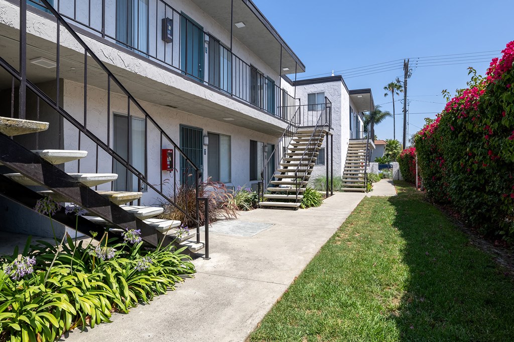 A building with a staircase and a red fire hydrant.