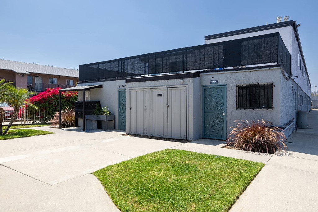 A building with a grey exterior and a black awning.
