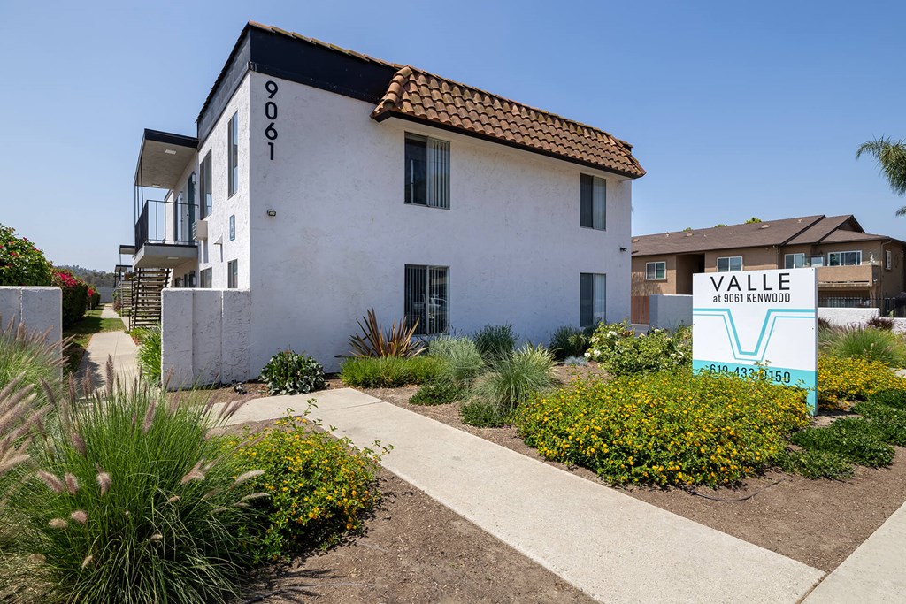 A white building with a sign that says