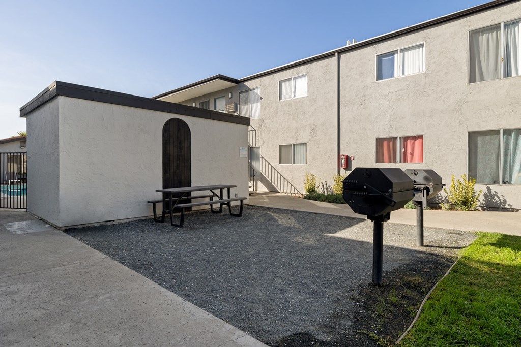 A small building with a picnic table in front of it.
