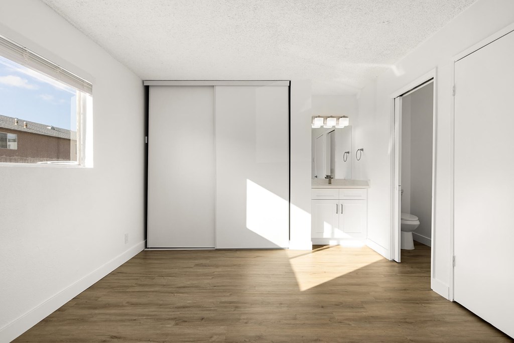 A white room with a sliding door and a window.
